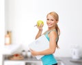 Sporty woman with scale and green apple Royalty Free Stock Photo