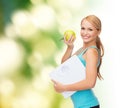 Sporty woman with scale and green apple Royalty Free Stock Photo