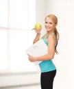 Sporty woman with scale and green apple Royalty Free Stock Photo