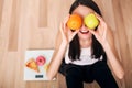 Sporty woman with scale and green apple and orange Royalty Free Stock Photo