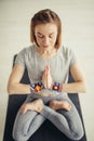 Sporty woman sitting cross-legged in lotus pose in bright room Royalty Free Stock Photo