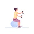 Sporty woman sitting fitness ball girl holding dumbbells doing exercises training in gym aerobic pilates workout healthy Royalty Free Stock Photo