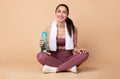 Sporty woman sitting on floor holding water bottle Royalty Free Stock Photo