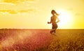 Sporty woman at sunset in wheat field Royalty Free Stock Photo