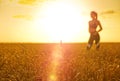 Sporty woman in wheat field Royalty Free Stock Photo