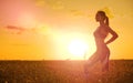 Sporty woman in wheat field Royalty Free Stock Photo