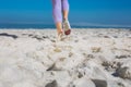 Sporty womans feet jogging on the sand Royalty Free Stock Photo
