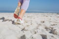 Sporty womans feet jogging on the sand Royalty Free Stock Photo