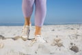 Sporty womans feet on the sand Royalty Free Stock Photo