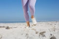 Sporty womans feet on the sand Royalty Free Stock Photo
