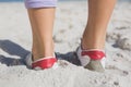 Sporty womans feet on the sand Royalty Free Stock Photo