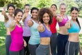 Sporty women gesturing thumbs up in park