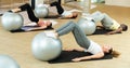 Sporty women and men doing exercises with pilates balls Royalty Free Stock Photo