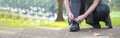 Sporty women are tied with running shoes to run exercise in the morning. Portrait of beautiful Women exercising in the park on Royalty Free Stock Photo