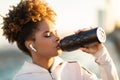 Sporty Young African American Woman Drinking Water From Bottle After Training Outdoors Royalty Free Stock Photo