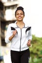 Sporty young african woman running outdoors Royalty Free Stock Photo