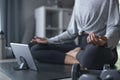 Sporty young Asian woman exercising at home, watching fitness video on Internet or having online fitness class Royalty Free Stock Photo