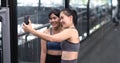 Sporty young asian women with friends taking picture of her friend using mobile phone Royalty Free Stock Photo