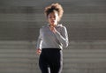 Sporty young black woman running outdoors Royalty Free Stock Photo