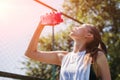 Sporty young blonde woman with sporty bottle with cool water pours water on herself on sports field Royalty Free Stock Photo