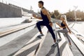Sporty young couple, man and woman running together on the city stairs, sport, healthy lifestyle Royalty Free Stock Photo
