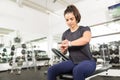 Sporty Female Checking Fitness Activity On Smart Watch In Gym