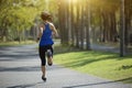 Young fitness woman running at tropical park Royalty Free Stock Photo