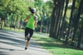 fitness woman running at tropical park Royalty Free Stock Photo