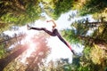Sporty girl running in sunny forest