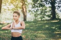 Sporty young girl doing yoga at public park in the morning,Female exercising on green grass Royalty Free Stock Photo