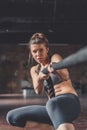 Sporty young girl pulling a rope