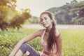 Sporty young girl sitting after break workout at park,Happy and smiling,Relaxing time,Positive thinking