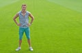Sporty young man on green training field Royalty Free Stock Photo