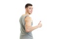 Sporty young man with muscles turned his back to the camera smiling and shows the class Royalty Free Stock Photo