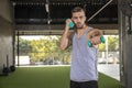 Sporty young man training with dumbbells with copy space Royalty Free Stock Photo