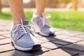 Sporty young man in training shoes on sunny day, closeup Royalty Free Stock Photo