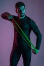 Sporty young man working out with resistance loop band Royalty Free Stock Photo