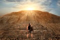 Sporty young tourist on the background of a Teotihuacan sunset. Pyramid of the Sun. Travel and freedom concept.