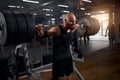 Bodybuilder doing squats with barbell row