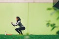 Sporty young woman doing squat exercise outdoors Royalty Free Stock Photo