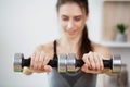 Sporty young woman doing squat morning exercise alone in living room Royalty Free Stock Photo