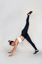 Sporty young woman doing stretching exercises in tracksuit isolated on pink background. Royalty Free Stock Photo