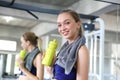 Sporty young woman drinking water at gym. Female drink water.  Beautiful young caucasian woman drinking water after doing fitness Royalty Free Stock Photo