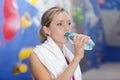 sporty young woman drinking water in gym Royalty Free Stock Photo