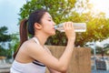 Sporty young woman drinking water after jogging Royalty Free Stock Photo