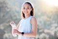 Im all about making healthy choices. a sporty young woman holding a water bottle while standing outside. Royalty Free Stock Photo