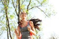 Sporty young woman listening to music while running in park Royalty Free Stock Photo