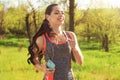 Sporty young woman listening to music while running in park Royalty Free Stock Photo