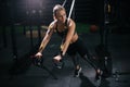 Sporty young woman with perfect muscular body working out on simulator during sport training at gym Royalty Free Stock Photo