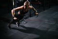 Sporty young woman with perfect muscular body working out on simulator during sport training at gym Royalty Free Stock Photo